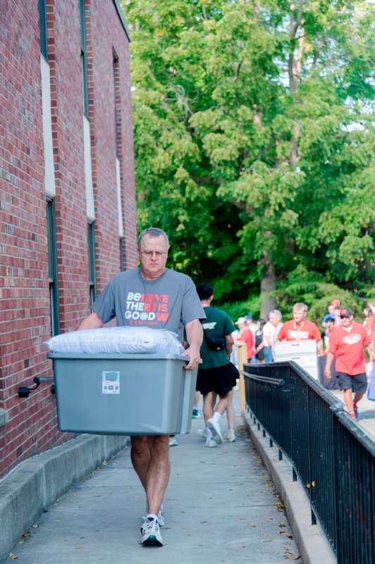 a man carrying a large container