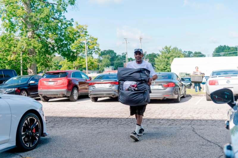 a man carrying a large bag of luggage