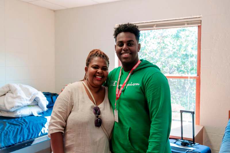 a man and woman standing together smiling