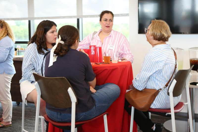 a group of people sitting around a table