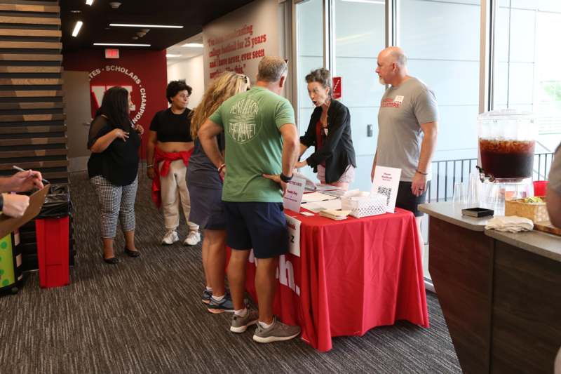 a group of people standing around a table