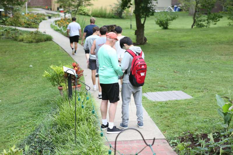 a group of people walking on a sidewalk