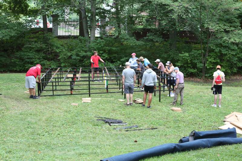 a group of people standing around a structure