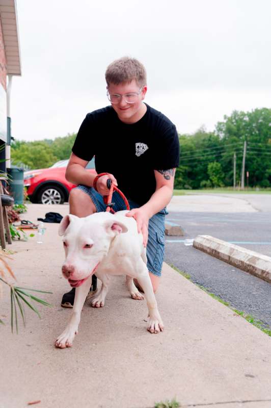 a man petting a dog