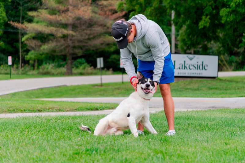 a man petting a dog