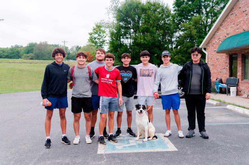 a group of people posing for a photo with a dog