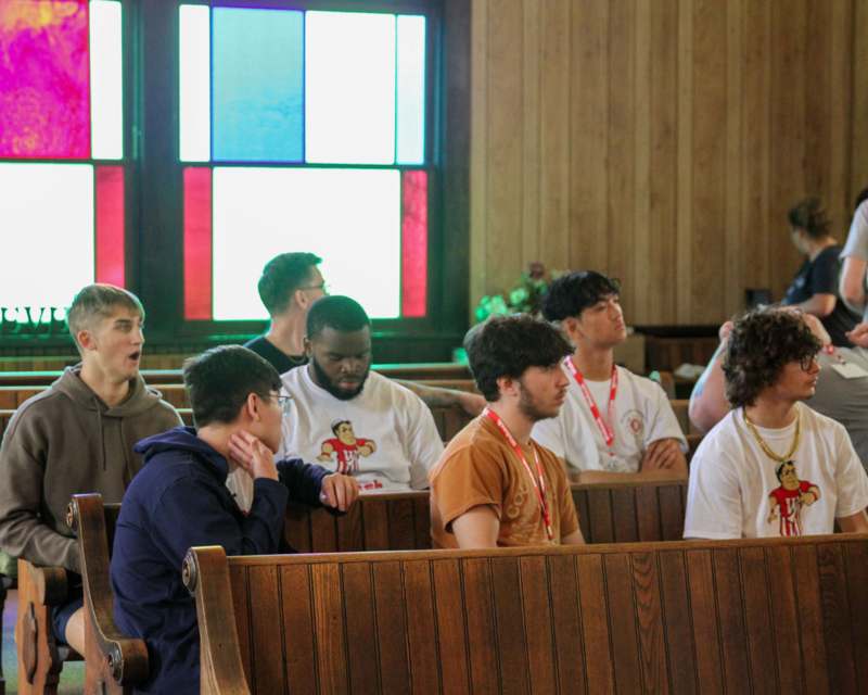 a group of people sitting in a church pews