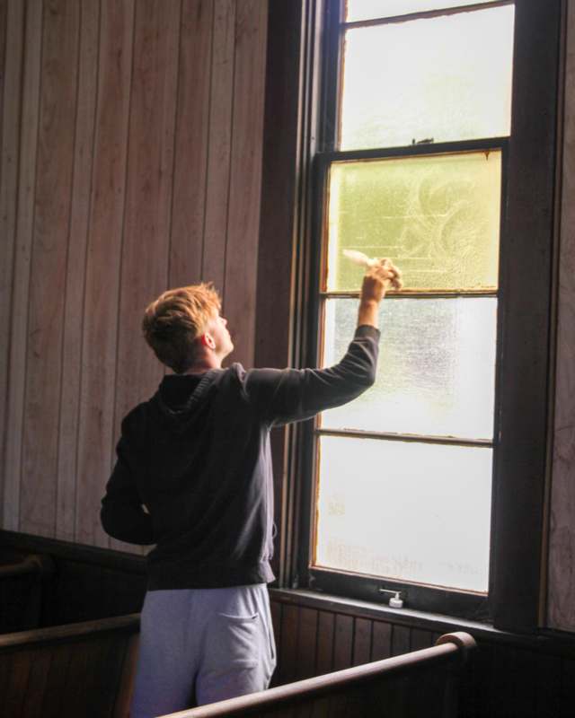 a person cleaning a window