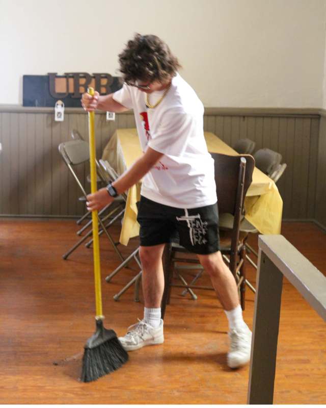 a man sweeping the floor