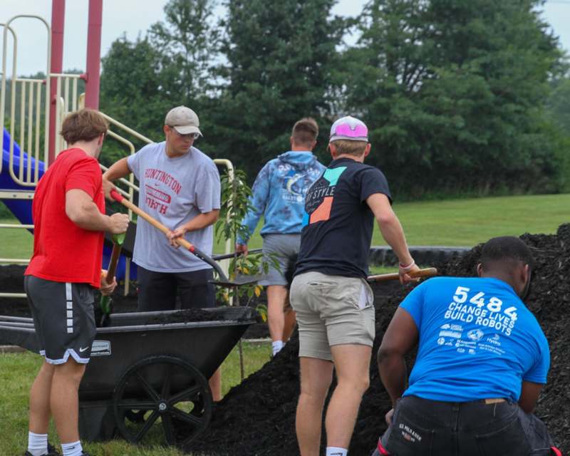 a group of people working in a park