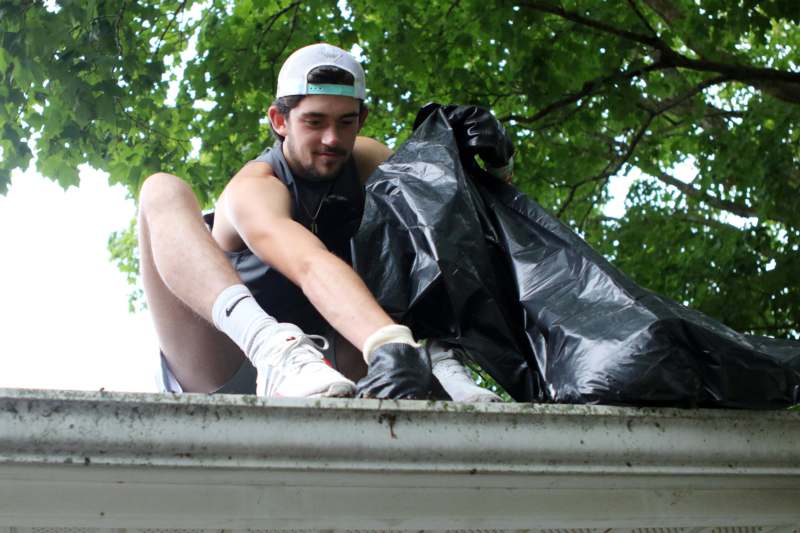 a man sitting on a ledge with a black bag