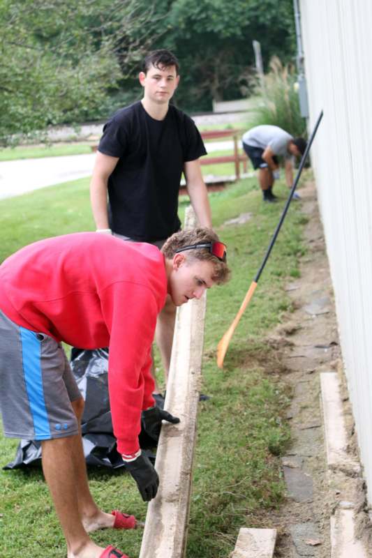 a group of men working on a wall