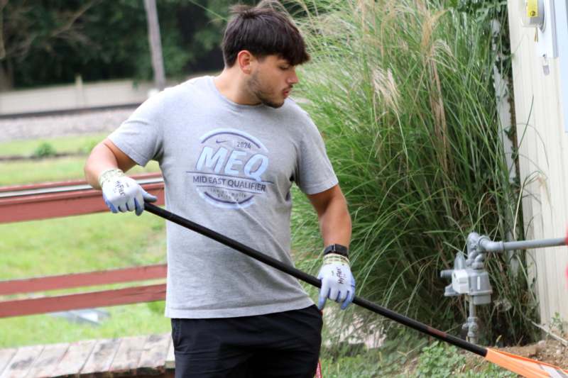 a man holding a stick