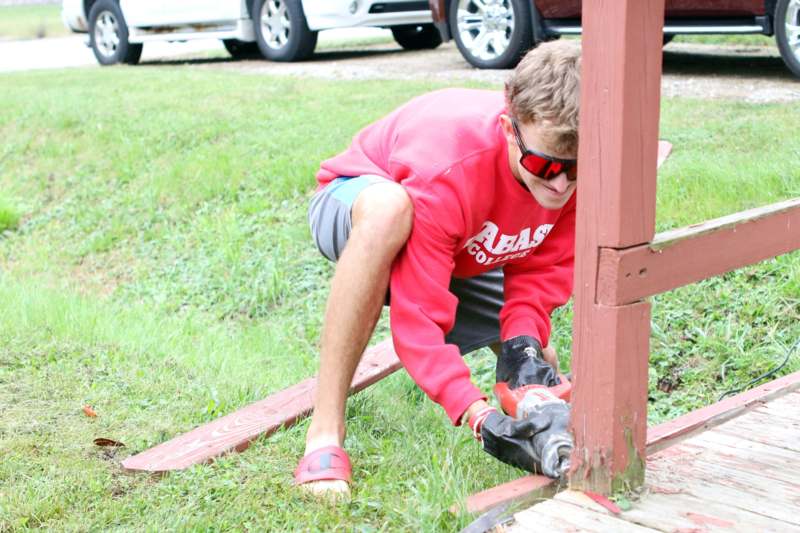 a man using a power tool to cut wood