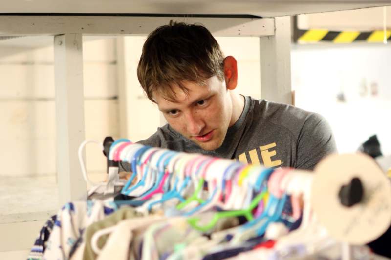 a man looking at clothes on a swinger