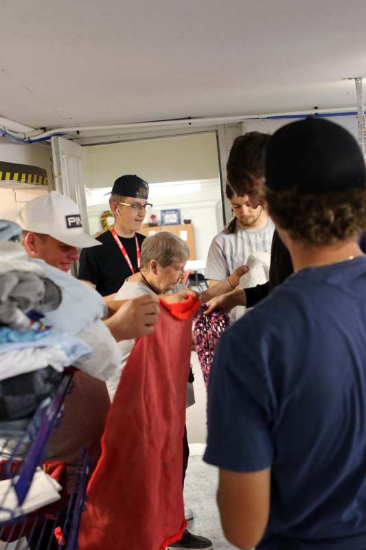 a group of people looking at a red shirt