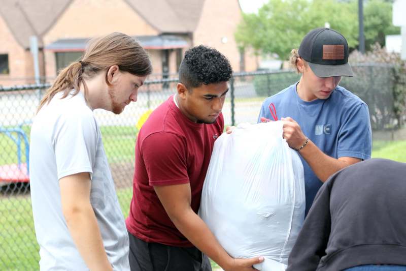 a group of men holding a bag