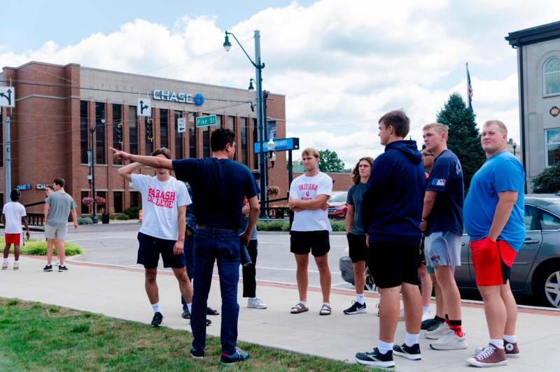 a group of people standing on a sidewalk