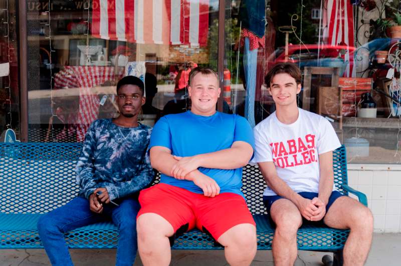 a group of men sitting on a bench