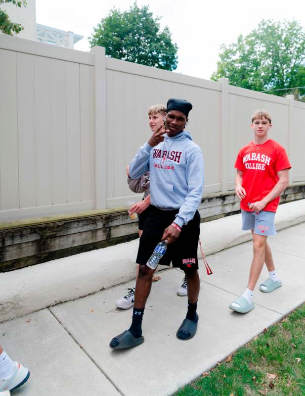 a group of men standing on a sidewalk