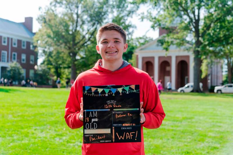 a boy holding a sign