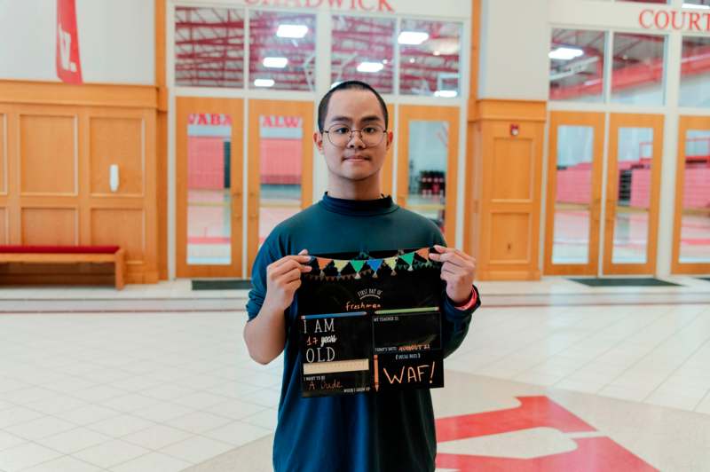 a man holding up a sign