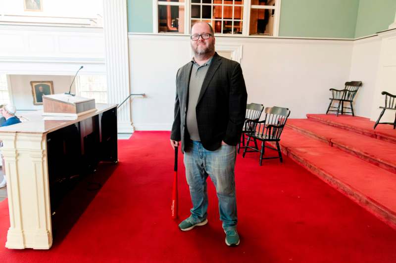 a man standing in a room with a bat