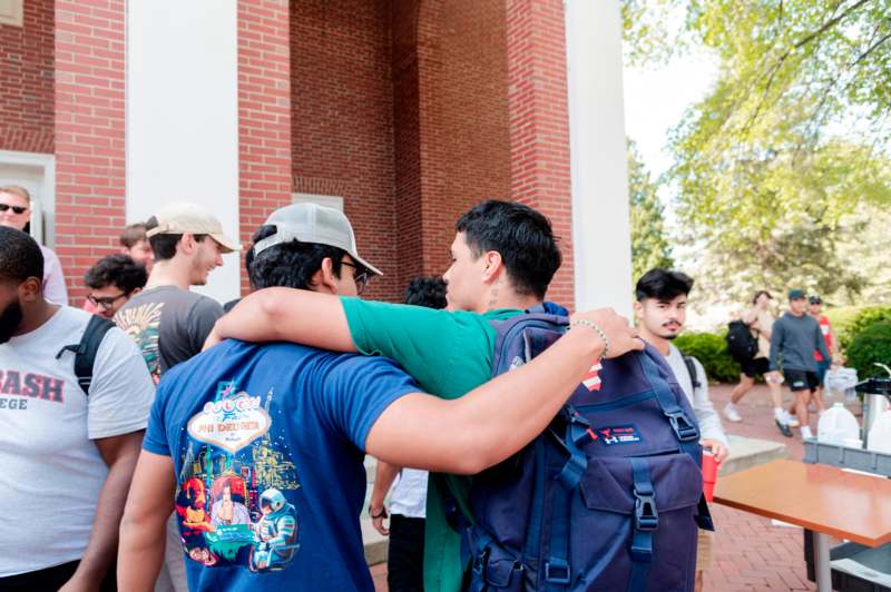 a group of men hugging outside