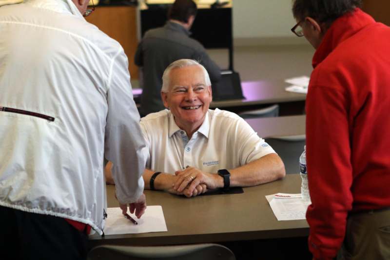 a man smiling at a table