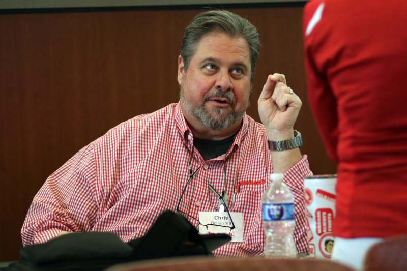 a man in a red and white checked shirt