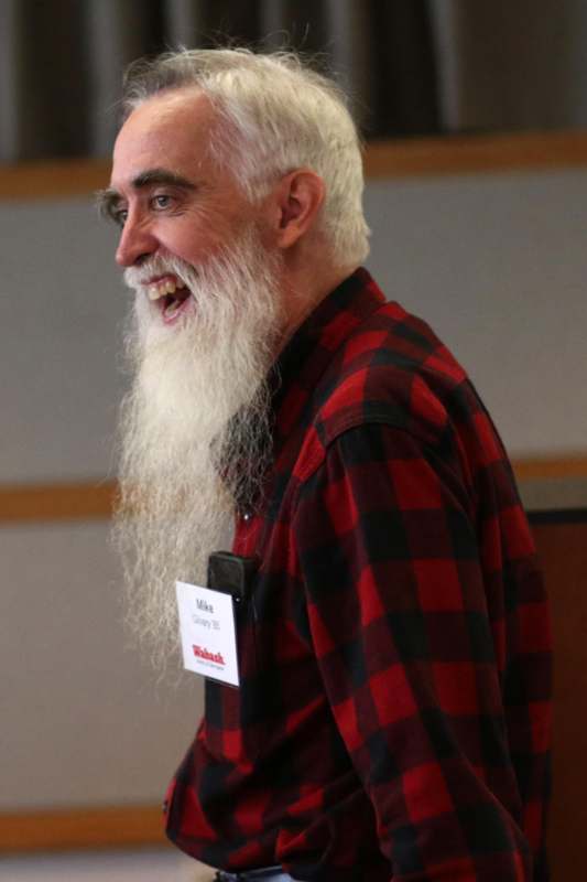 a man with a long beard laughing