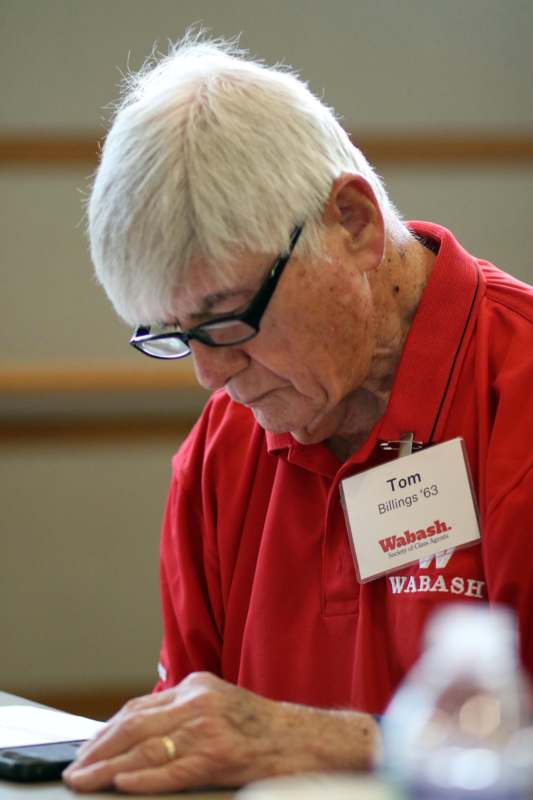 a man wearing glasses and a name tag