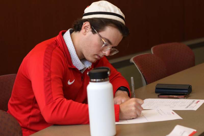 a man writing on a paper