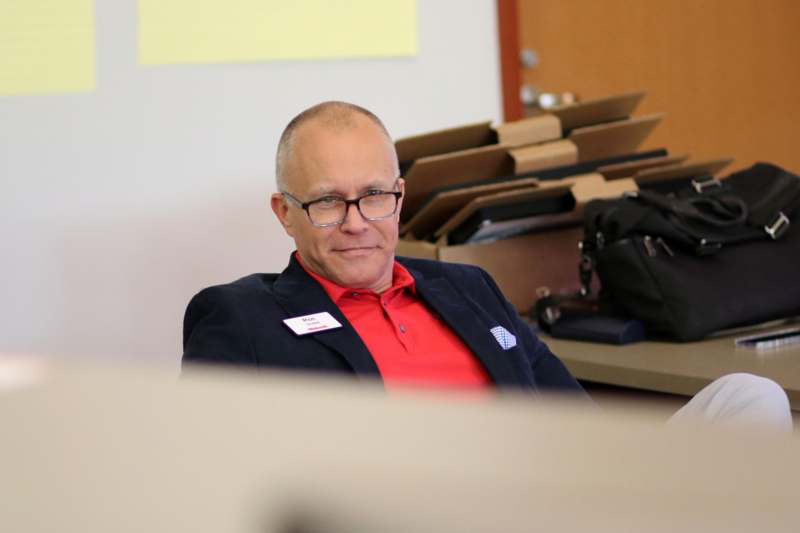 a man in a suit and glasses