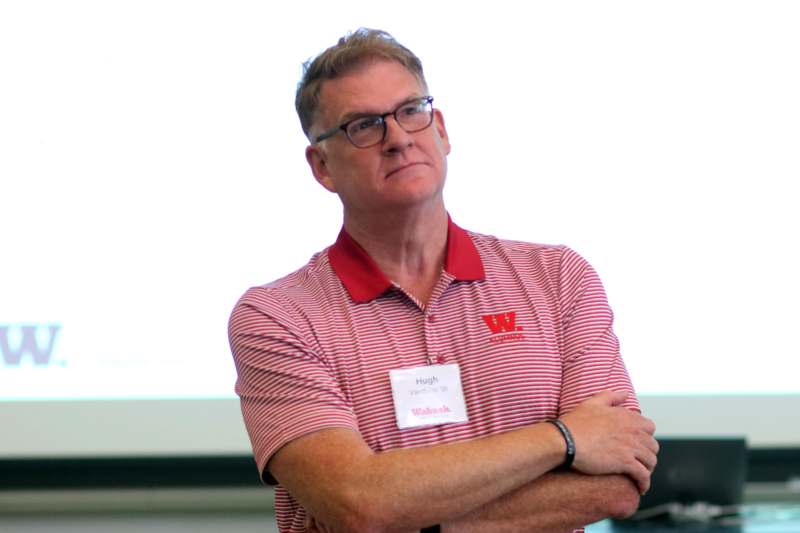 a man with glasses and a name tag