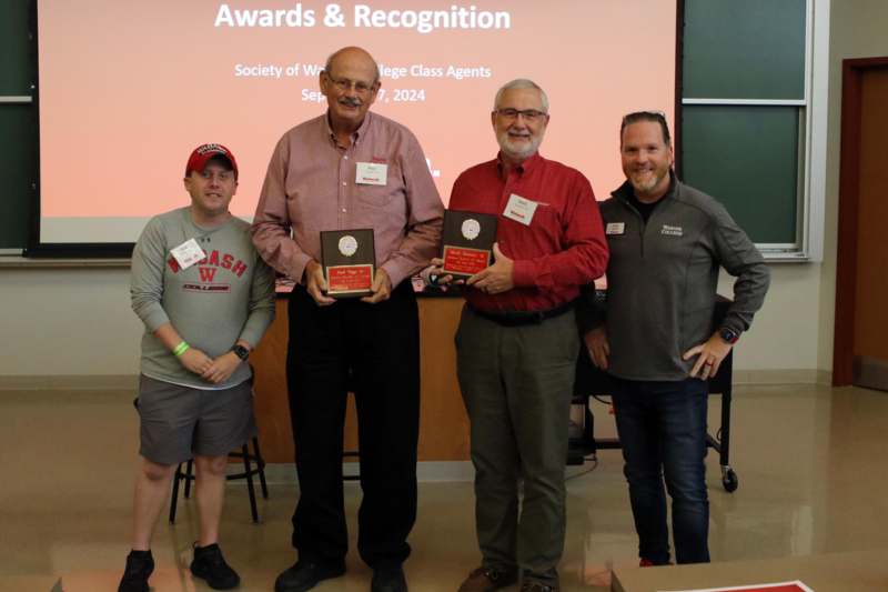 a group of men holding awards