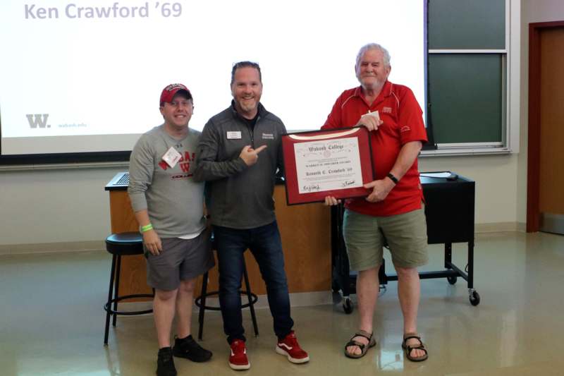 a group of men holding a certificate