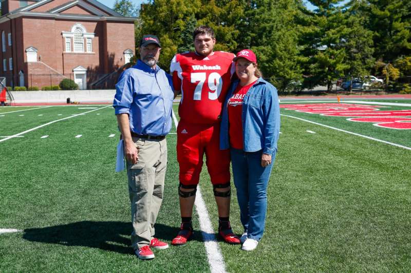 a group of people standing on a football field