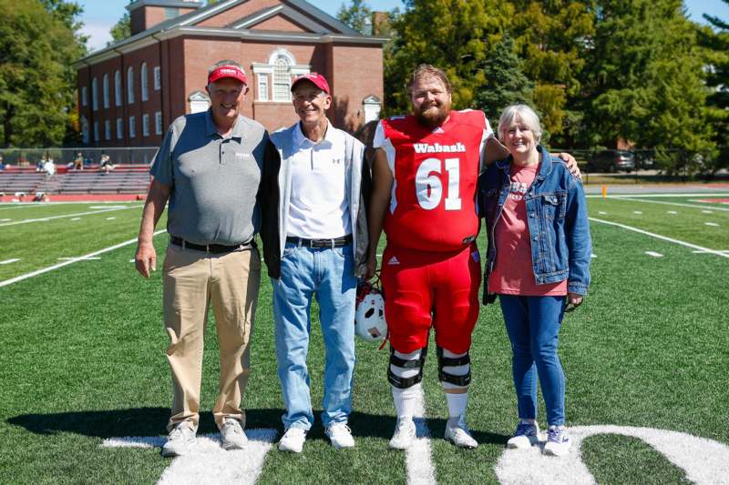 a group of people standing on a football field