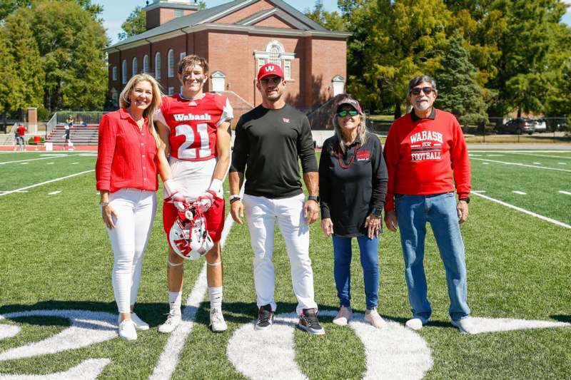 a group of people standing on a football field