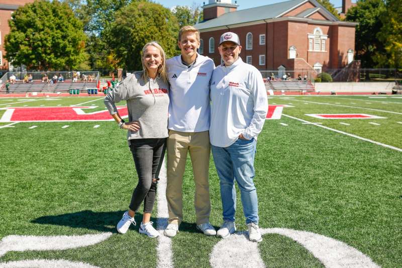 a group of people standing on a football field