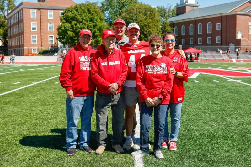 a group of people posing for a photo on a football field