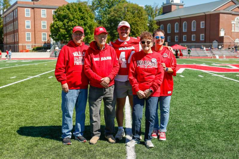 a group of people standing on a football field