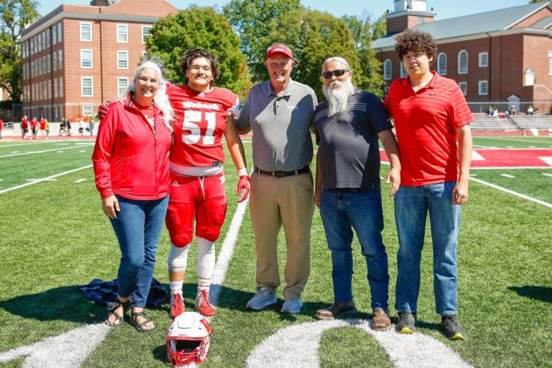 a group of people standing on a football field