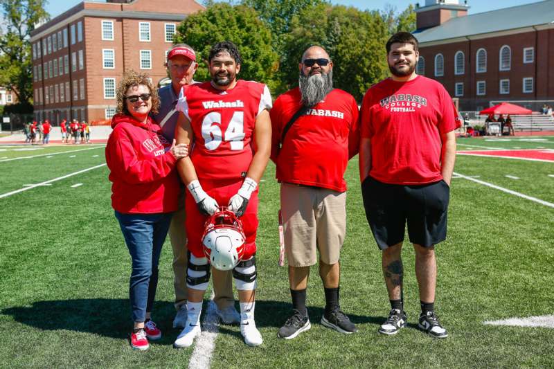 a group of people standing on a football field