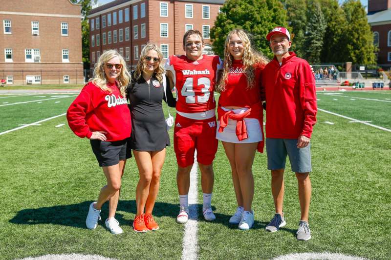 a group of people posing for a picture on a football field