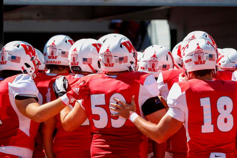 a group of football players in a huddle