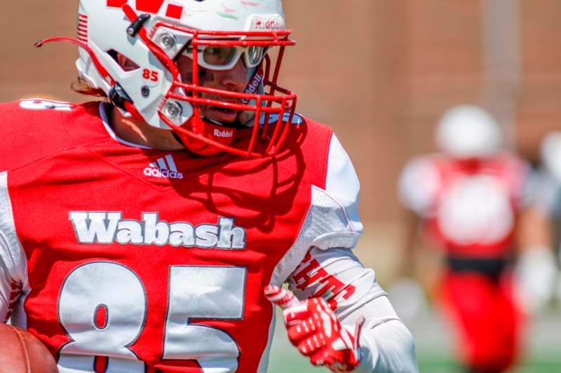 a football player wearing a red and white uniform