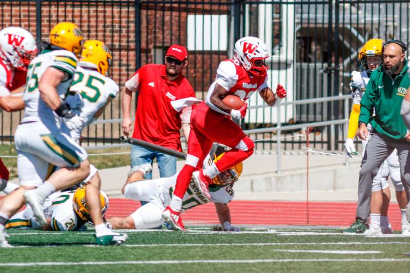 a football player running with a ball