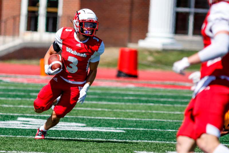 a football player running with a football